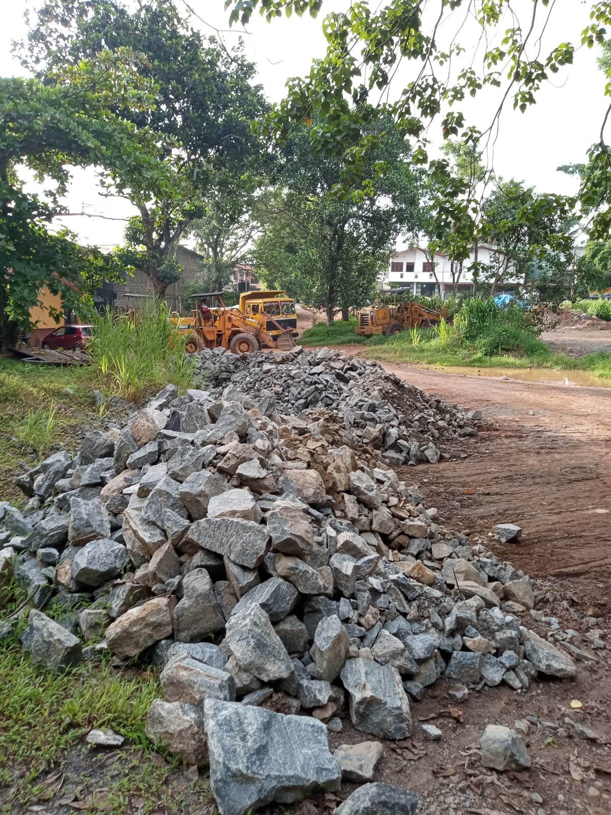 Hydraulic rock breaker excavator working a granite quarry face